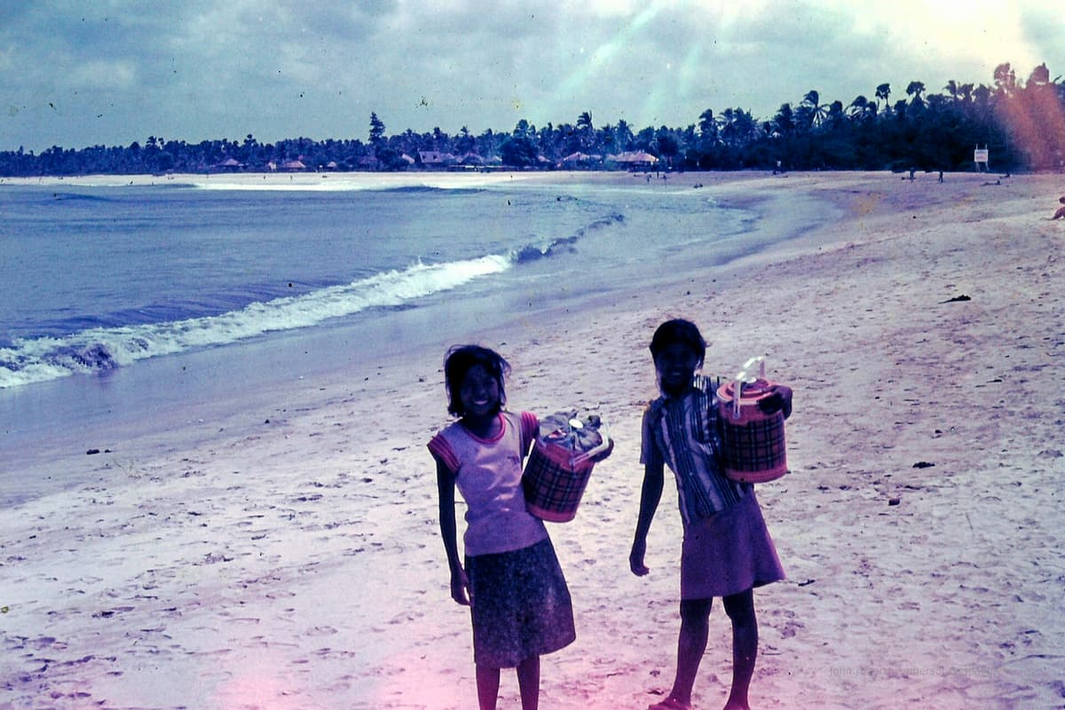Bali beach day | Bali | Go Bali Visa Agency Travelers walking a tropical Bali beach with turquoise water and palms