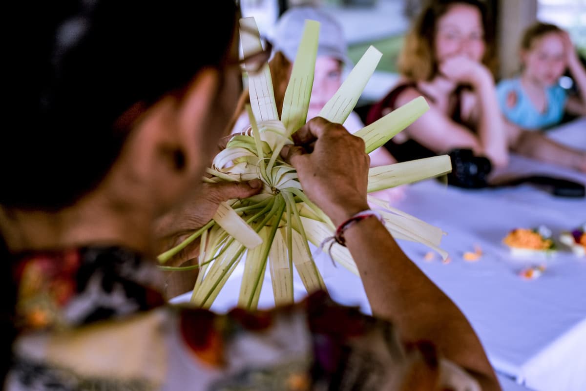 Canang sari offerings | Bali | Go Bali Visa Agency Balinese woman preparing canang sari flower offerings for daily temple ceremony