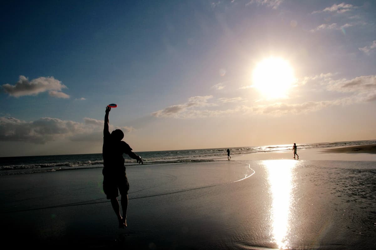 Seminyak Beach | Bali | Go Bali Visa Agency Seminyak Beach shoreline with sun umbrellas and calm surf in Bali