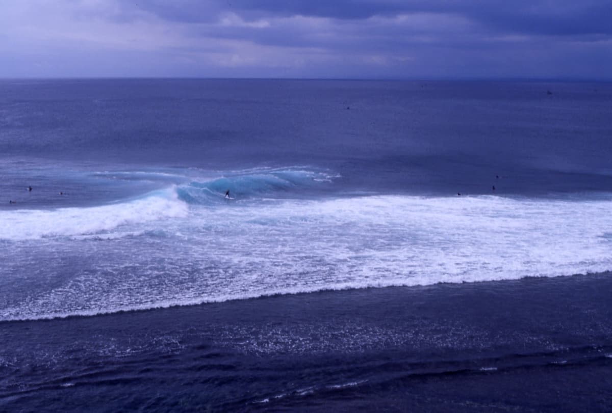 Surfing at Uluwatu | Bali | Go Bali Visa Agency Surfer riding a breaking wave at Uluwatu on Bali's Bukit Peninsula
